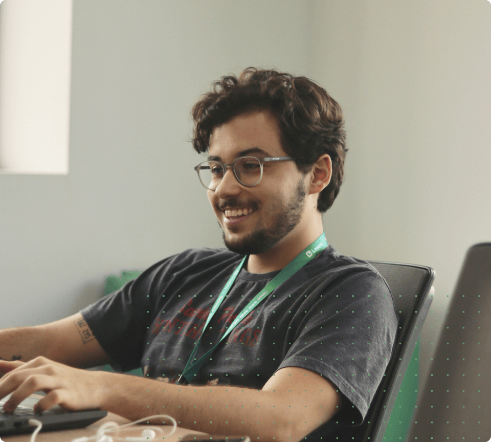 A man smiling with a laptop