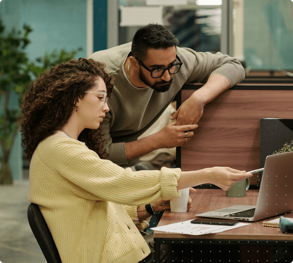 A man and a woman looking at a laptop
